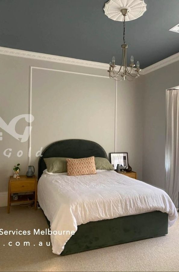 Bedroom with a deep green feature wall