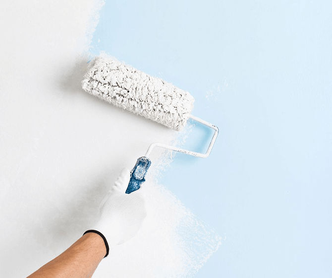 Roller laying a fresh coat on an interior wall